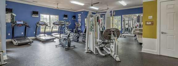 A spacious gym with a variety of exercise equipment.
