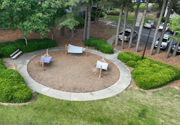 an aerial view of a backyard with a fire pit and a seating area