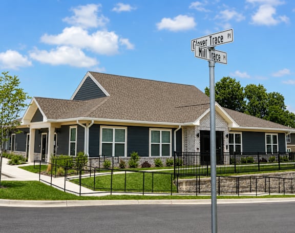 A house with a sign that says "Flower Trace" in front of it.