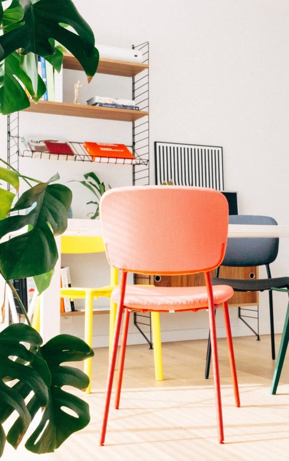 a living room with a dining room with chairs and a table