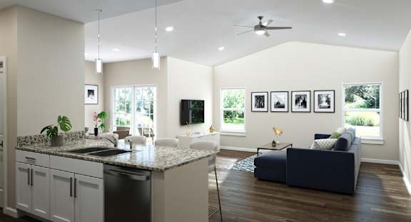 A modern kitchen with a large island and a living room with a couch.
