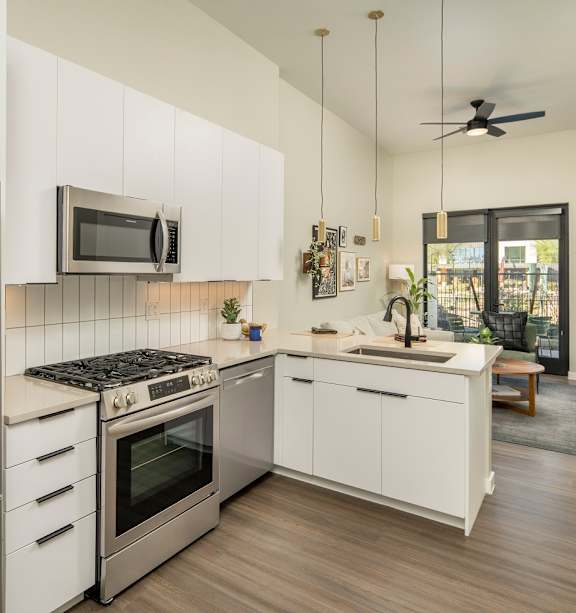 a kitchen with a large island with three stools