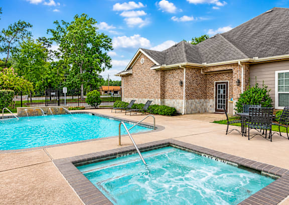 A house with a pool and a hot tub in the backyard.