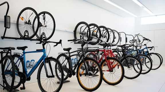 A wall of bicycles in a bike shop.