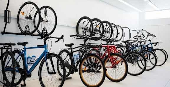 A wall of bicycles in a bike shop.