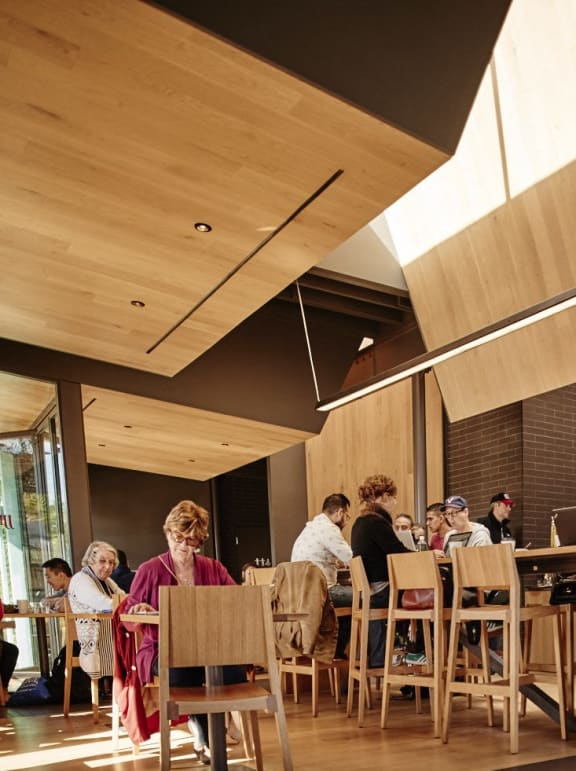a group of people sitting at tables in a restaurant