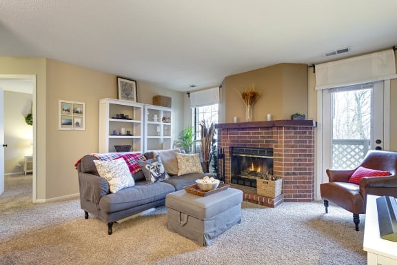 a living room with a fireplace and a couch  at Regency Woods, Minnetonka, MN, 55305