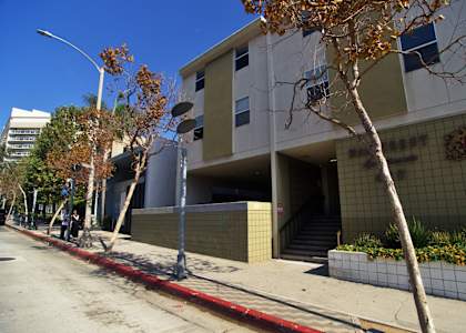 A building with a red line on the sidewalk in front of it.
