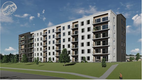 A modern apartment building with balconies and a clear sky in the background.