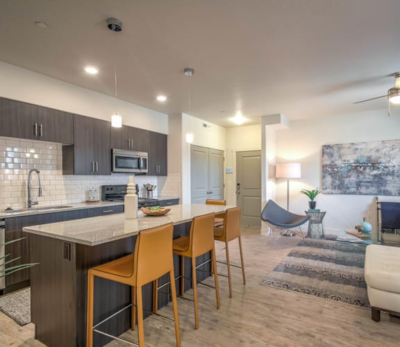 a living room with a kitchen and a dining room
