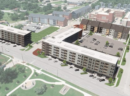 an aerial view of an apartment building and a parking lot