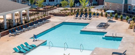an aerial view of a swimming pool with lounge chairs Matthews, NC 28105