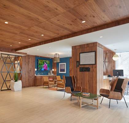 the lobby or reception area of a home with a wood paneled ceiling and a