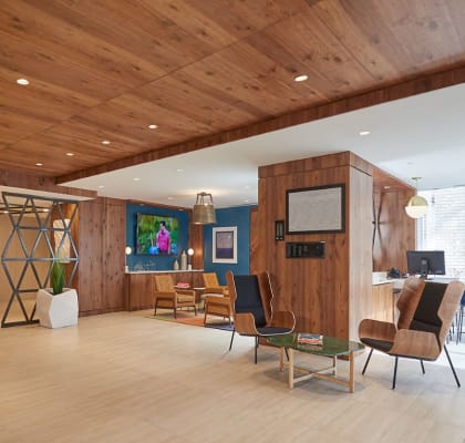 the lobby or reception area of a home with a wood paneled ceiling and a