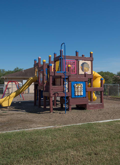 a playground with a playset in a yard