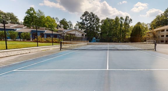 a tennis court at the enclave at woodbridge apartments in sugar land, tx