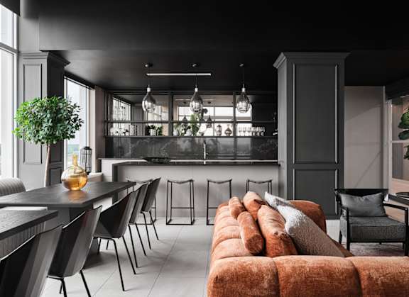 A modern living room with a long brown couch and black chairs. at Petries Landing I Apartments , Ottawa, K4A 1K4