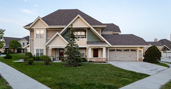 a house with a lawn and a driveway