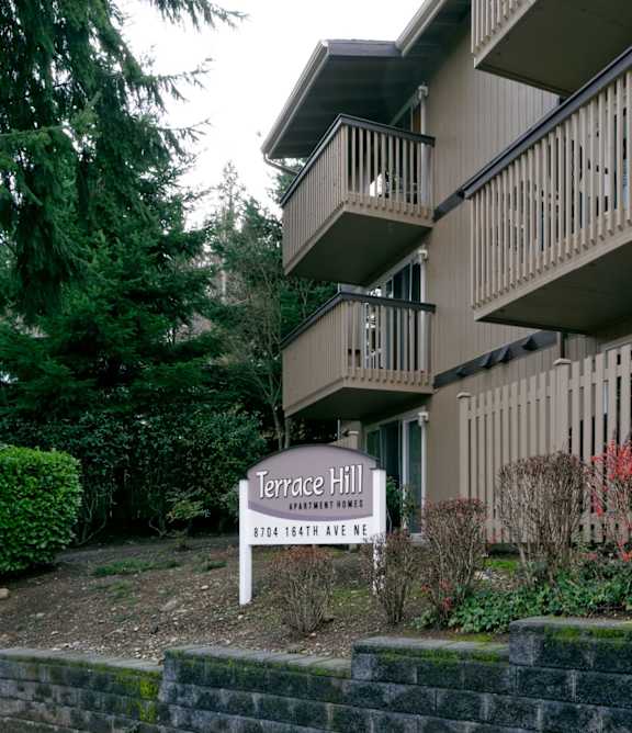 A sign in front of a building that says Terrace Hill.