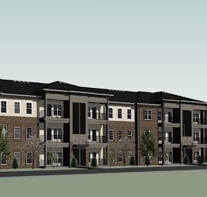 A large apartment building with multiple balconies and doors.