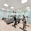 A gym with treadmills, exercise bikes, and weight machines.