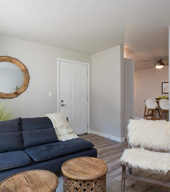 A living room with a blue couch and a wooden coffee table.