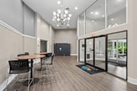 A conference room with a table, chairs, and a chandelier.