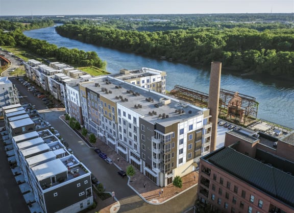 an aerial view of an apartment complex with a river in the background at East 51 At Rocketts Landing, Richmond, 23231