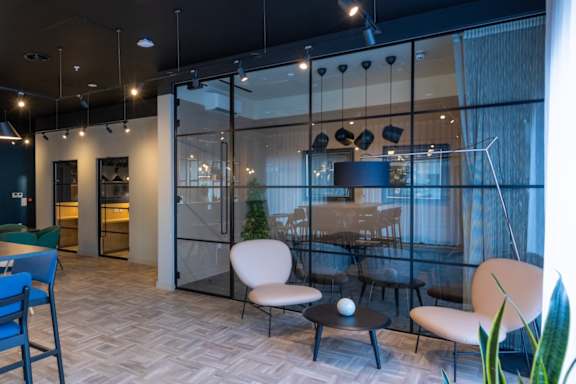 A room with a glass wall and a table with chairs.