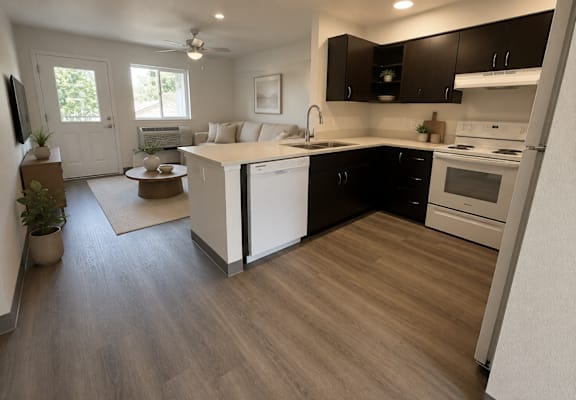 A kitchen with black cabinets and white appliances.