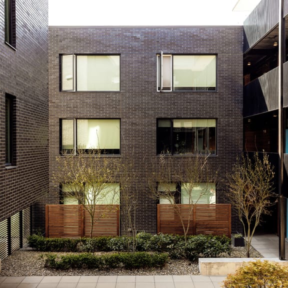 a brick building with a courtyard in front of it