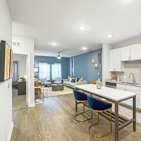 a kitchen and living room with a table and chairs