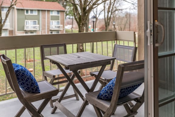 Private balcony with folding table and chairs at The Brook At Columbia Apartments, Columbia