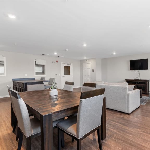 a living room with a wooden table and chairs