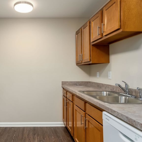 a kitchen with wood cabinets and white appliances