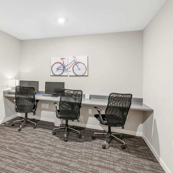 a room with three desks and three chairs
