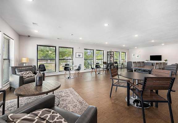 a living room with couches and chairs and a table