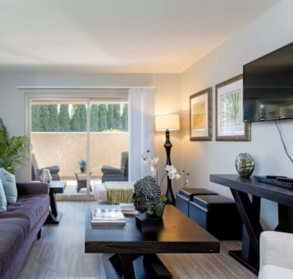 A modern living room with a purple couch and a coffee table.