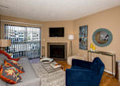 Thumbnail 9 of 37 - Living Room with Fireplace at Apres Apartments in Aurora, CO