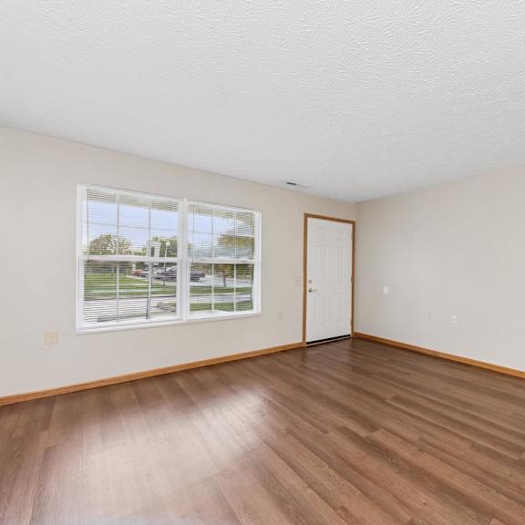A room with wooden floors and white walls.