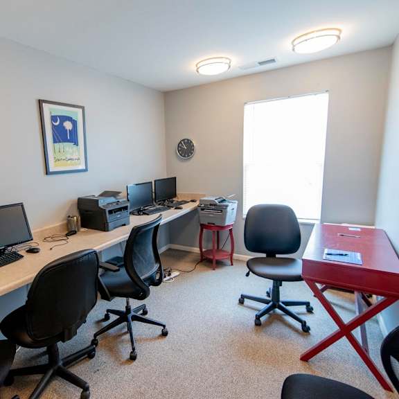 a room with four computers and four chairs