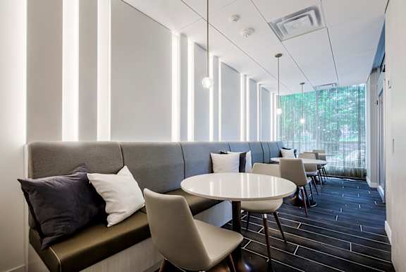 A long row of chairs are lined up in a room.
