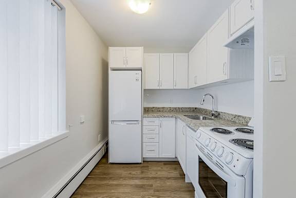 A white kitchen with a refrigerator, stove, and cabinets.at 107 Redpath, Toronto, M4S 2J9