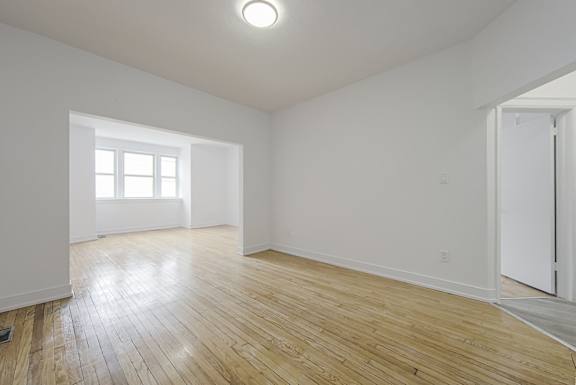 A room with wooden floors and a window. at 723 Bloor Apartments, Canada