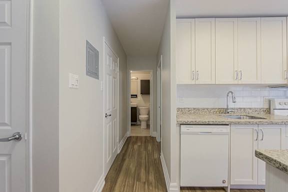 A white kitchen with a washer and dryer built in.at 107 Redpath, Toronto California