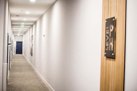A hallway with a sign that says "EXIT" on the door.