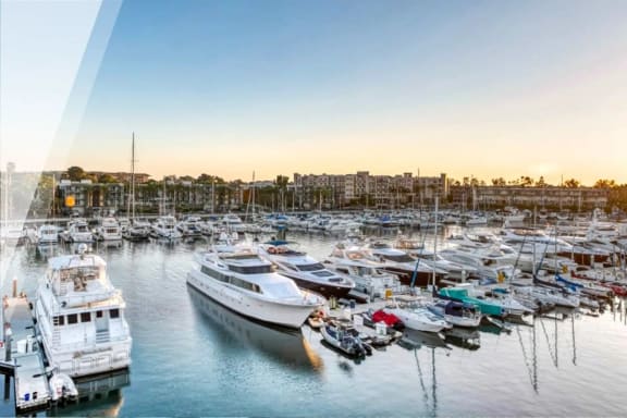 a marina filled with lots of boats at sunset
