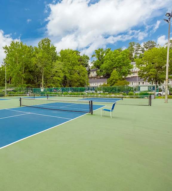 A tennis court with a blue surface and white lines.
