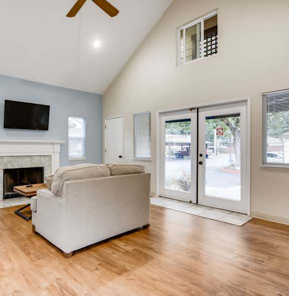 A living room with a fireplace and a flat screen TV.