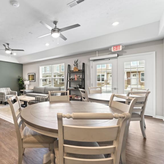 a dining room and living room with a table and chairs